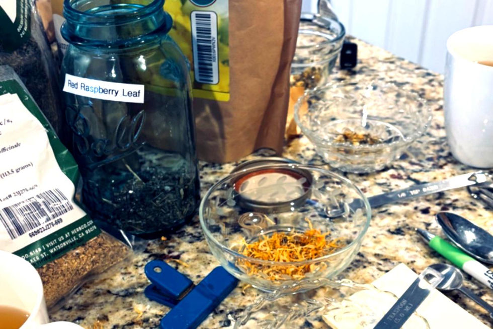 Herbal tea preparation on a kitchen counter with dried herbs and handwritten notes.