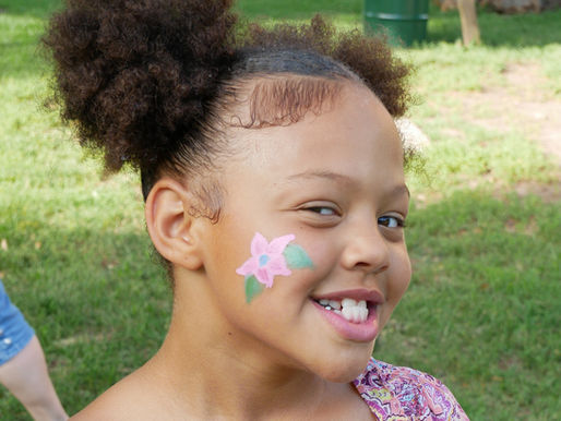 Girl with flower painted on her cheek