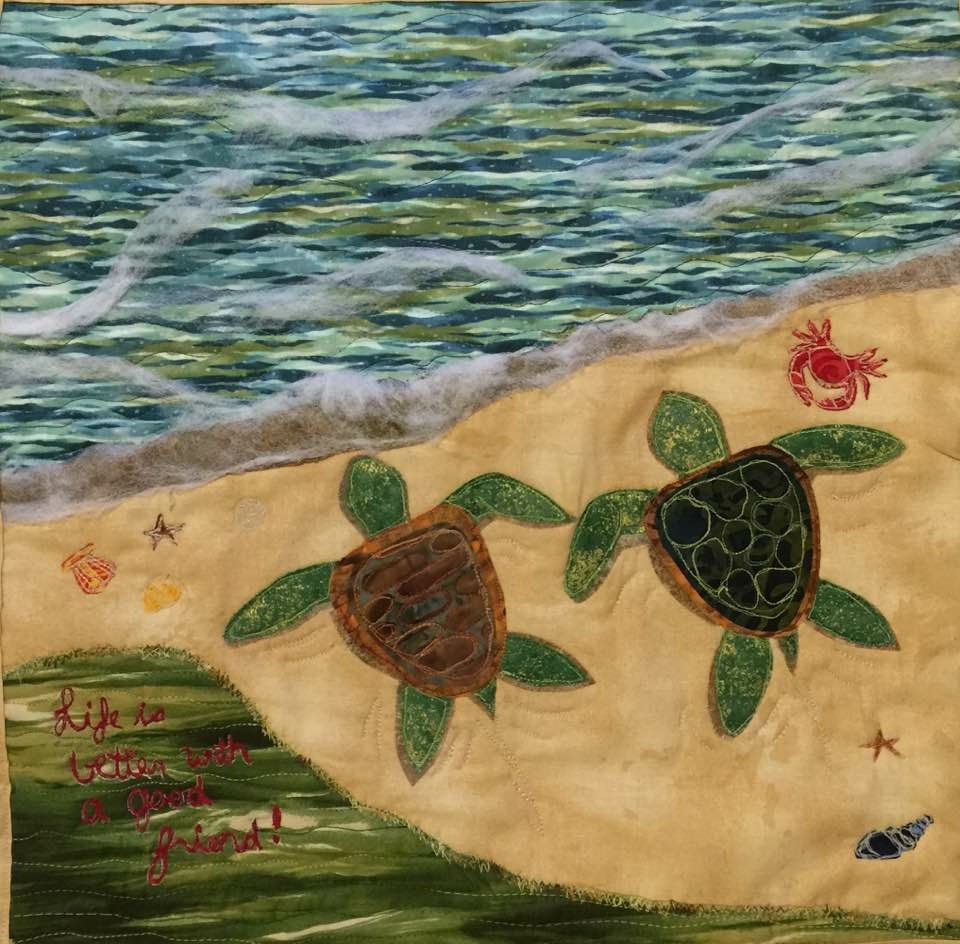 I made this small wall art quilt for my guild in Alaska to auction off. This is not a pattern. I used a few photos for inspiration and just started to make shapes. It made $125. I used batting to create the foam affect. I created little shells and a crab and used thread to give them more detail. Then I wrote a message that said “Life is better with a good friend!”