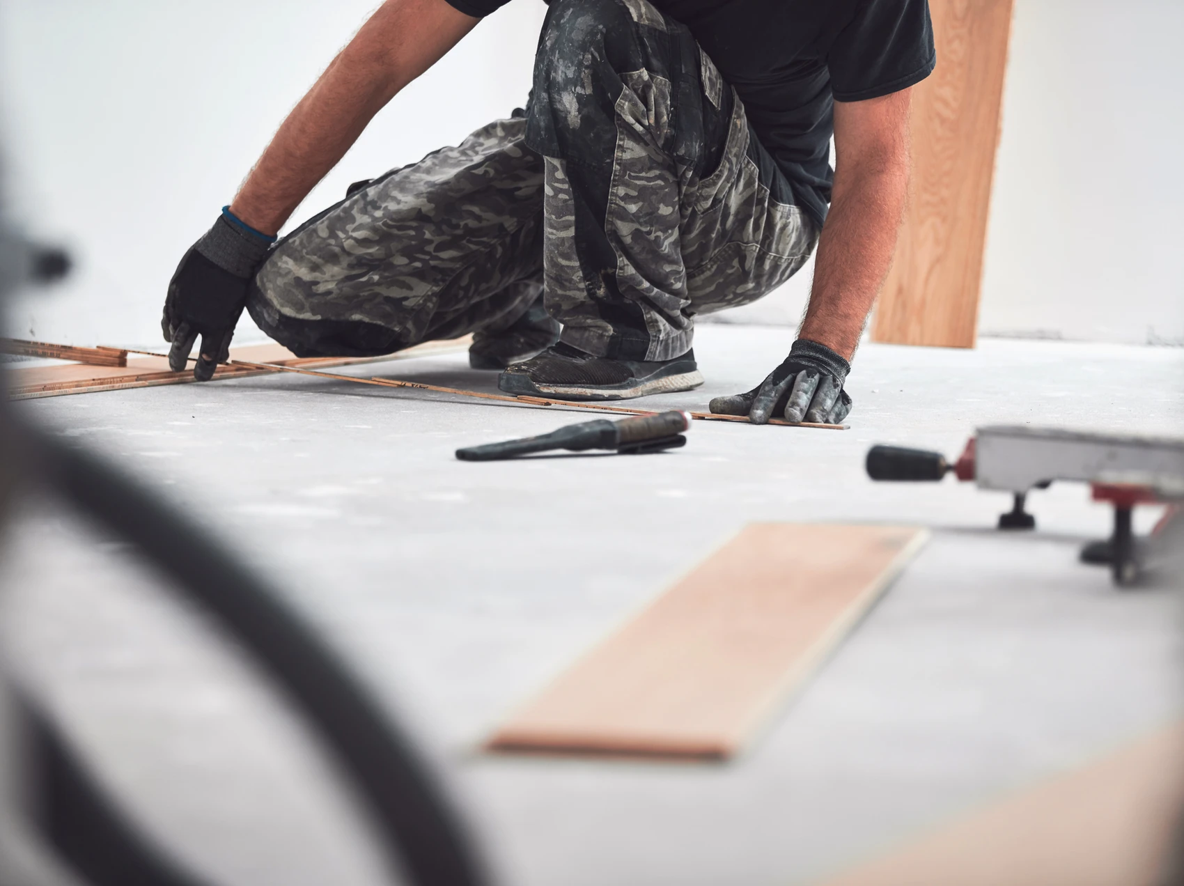A service crew measuring a plyboard