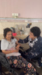 Neelam Mam smiling and talking warmly with elderly women at Sunrise Foundation's vridh ashram