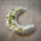 Peace Moon Tribute in whites and creams with light peach rose spray and ribbon edging