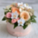 a smal floral hat box in peach pink and white