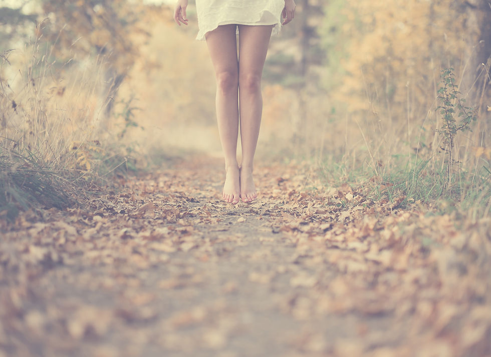 Barefoot tranquility amidst the serene embrace of nature's autumn foliage.