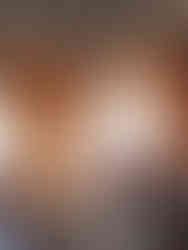 Interior of an office space in Vertikal Nydalen, featuring exposed concrete ceilings, natural light from large windows, and sustainably sourced furnishings. The design emphasizes comfort and sustainability, with clay-coated walls and embedded water pipes for natural temperature regulation.