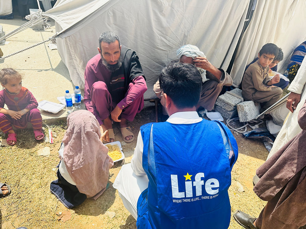 Photo of Life for Relief and Development USA (LIFE) team member serving hot meals to families in need.