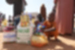 Photo of a mother and her daughter and son receiving a Life for Relief and Development (LIFE) food basket in Sudan.