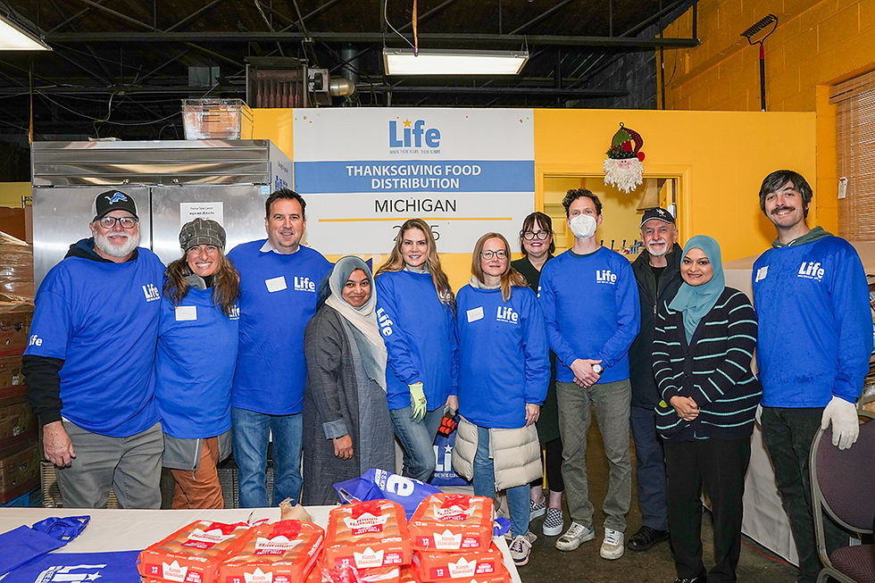 The Life for Relief and Development (LIFE) team gathers for a photo during their Thanksgiving food distribution event in Michigan, showcasing community support and generosity.