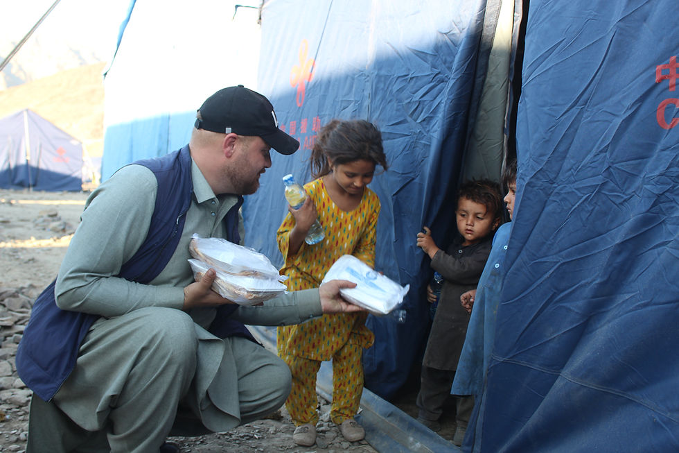 Photo of Life for Relief and Development (LIFE) team member distributing food to displaced persons in Gaza.