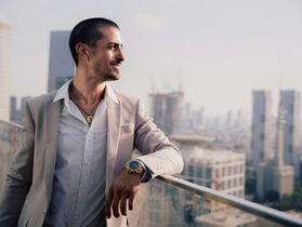 Man looks out a beautiful city view. 