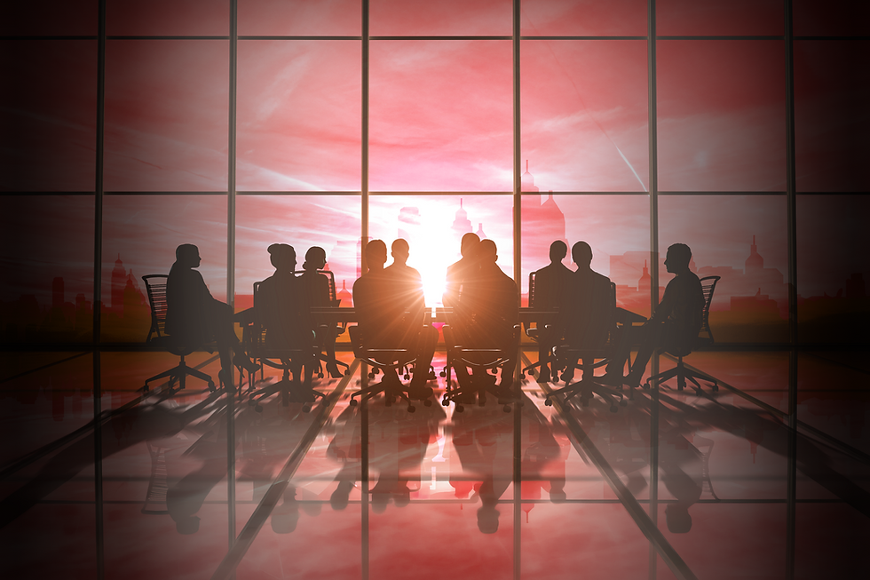 Silhouettes of a group of business professionals seated around a conference table in a modern boardroom, backlit by a red and orange sunrise through floor-to-ceiling windows overlooking a city skyline.