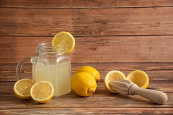 lemonade-glass-cup-wooden-table_114579-1