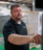 Sigma employee adjusting a machine wrapper