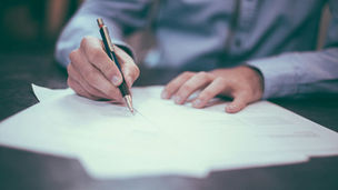 Freelancer creating a professional client proposal using a free proposal tool on a laptop in 2026