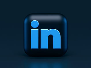 Freelancer updating LinkedIn profile to attract clients with optimized headline and services section in 2026