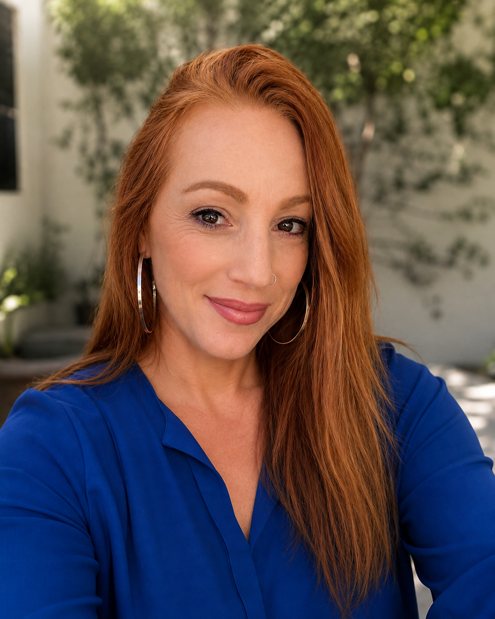 Portrait headshot of a woman in a royal blue top, vertical/portrait aspect ratio