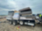 Low-angle view of a hotel loading area with wrapped mattresses ready for pickup