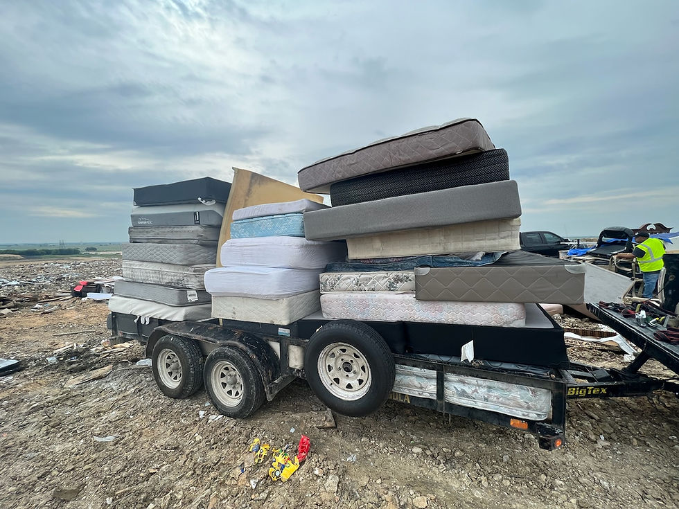 matresses on a trailer at the landfill