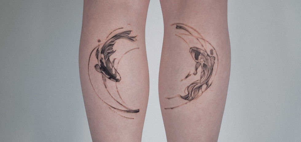 Black and grey koi fish tattoos mirrored on both calves, forming a circular composition on each leg.