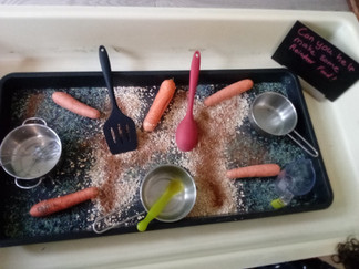 a tray with oats, chocolate, glitter, carrots, bowls, spoons , pans and spatulas