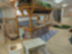 play kitchen slide and tables in a nursery setting