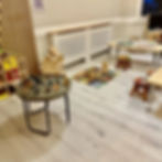 Nursery playroom including tables and mats with toys
