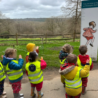 children looking at image of christopher robin jumping