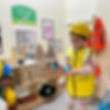Child playing at nursery in toy construction zone