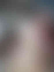 a group of children at a table colouring drawings of paws with numbers on