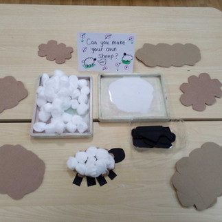 pieces of cardboard and cotton wool balls to create sheep