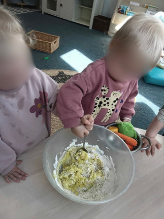 two children stiring mixture in a bowl