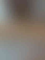 pine cones of various sizes on a table and a note asking children to put them in size order