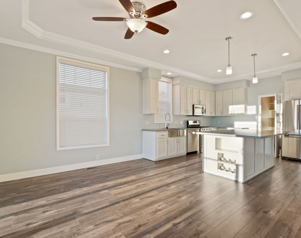 Spacious kitchen with island and hardwood floors.