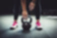 Woman in gym holding a kettlebell. Worki