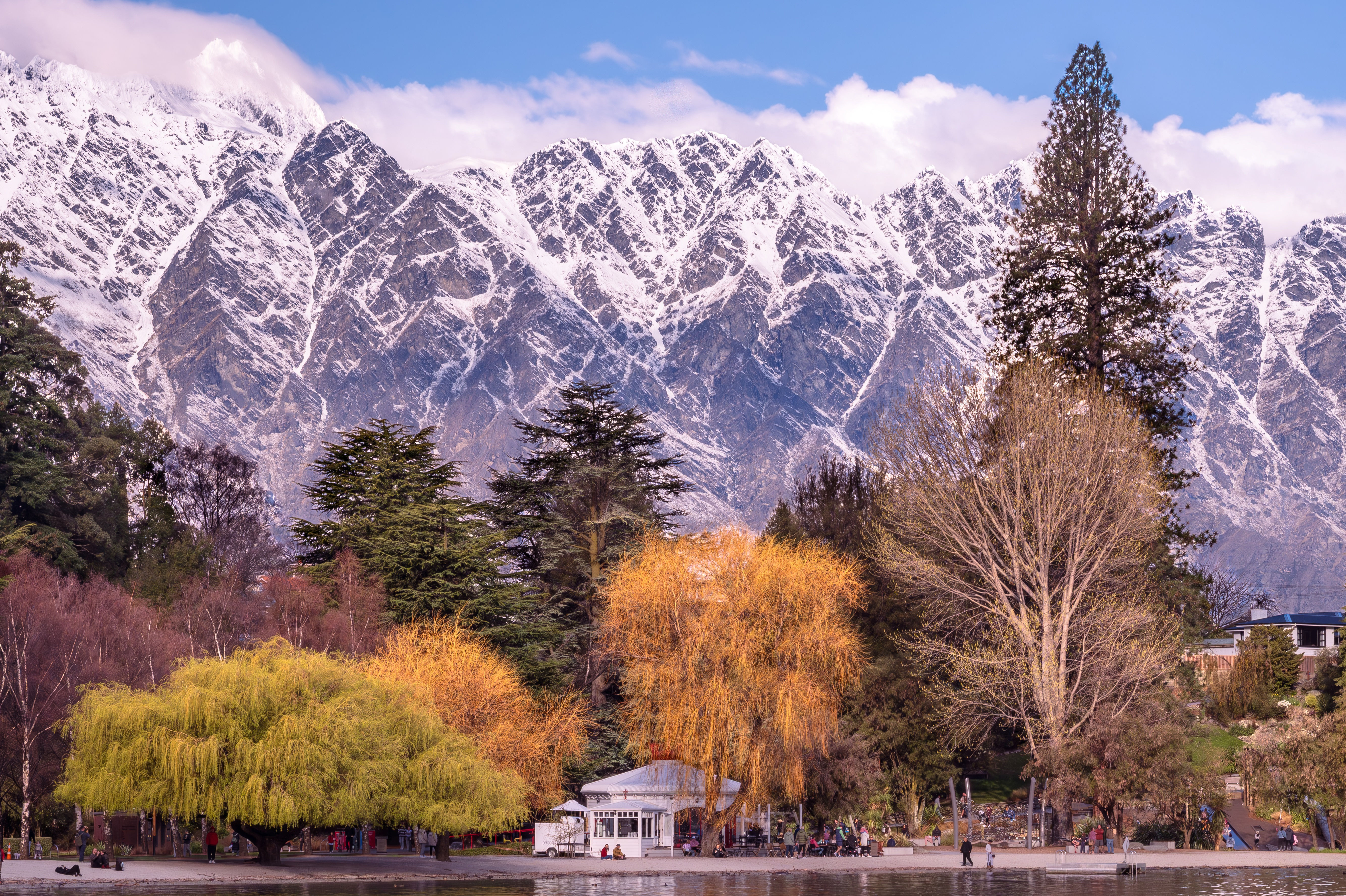 Queenstown lake front with gorgeous Autumn colours and snowy mountains.