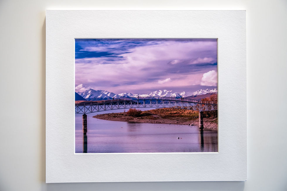 Example framed image of stunning Lake Tekapo with snow capped mountains in the background and the MacLaren Footbridge.
