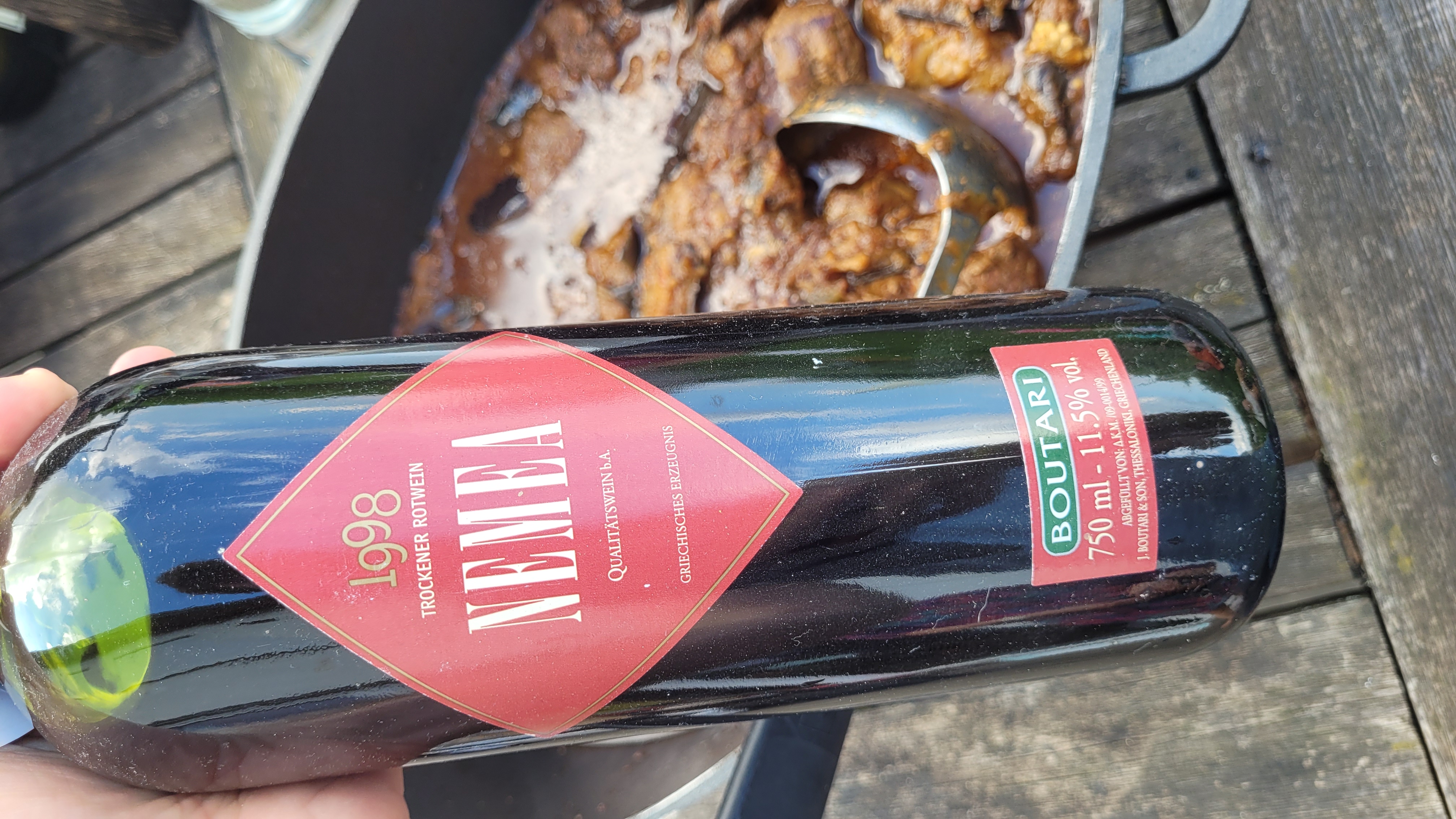 Bottle of Boutari Nemea 1998 above a pot of wild boar and aubergine stew