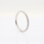 Delicate pavé diamond ring with a minimalist full eternity design on a thin gold band.