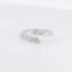 Modern open bypass diamond ring with mixed-cut baguette and round diamonds in fine gold.