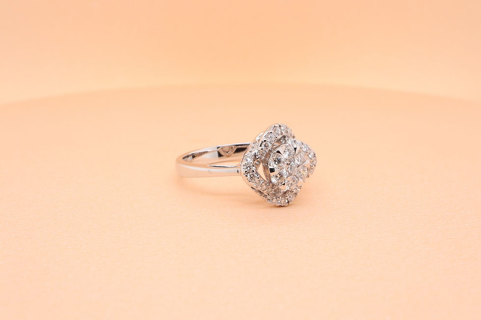 A love knot diamond cluster ring in gold with a swirling pavé halo and split shank band.