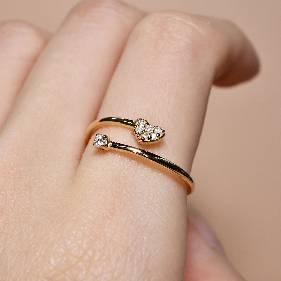Open heart and solitaire diamond ring in a bypass design, handcrafted in fine gold.
