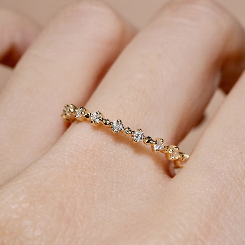 Thumbnail: Delicate shared-prong diamond ring with a minimalist half eternity design on a thin gold band.