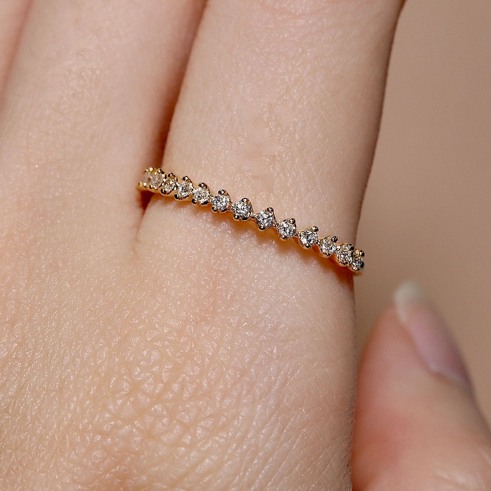 Thumbnail: Delicate shared-prong diamond ring with a minimalist half eternity design on a thin gold band.