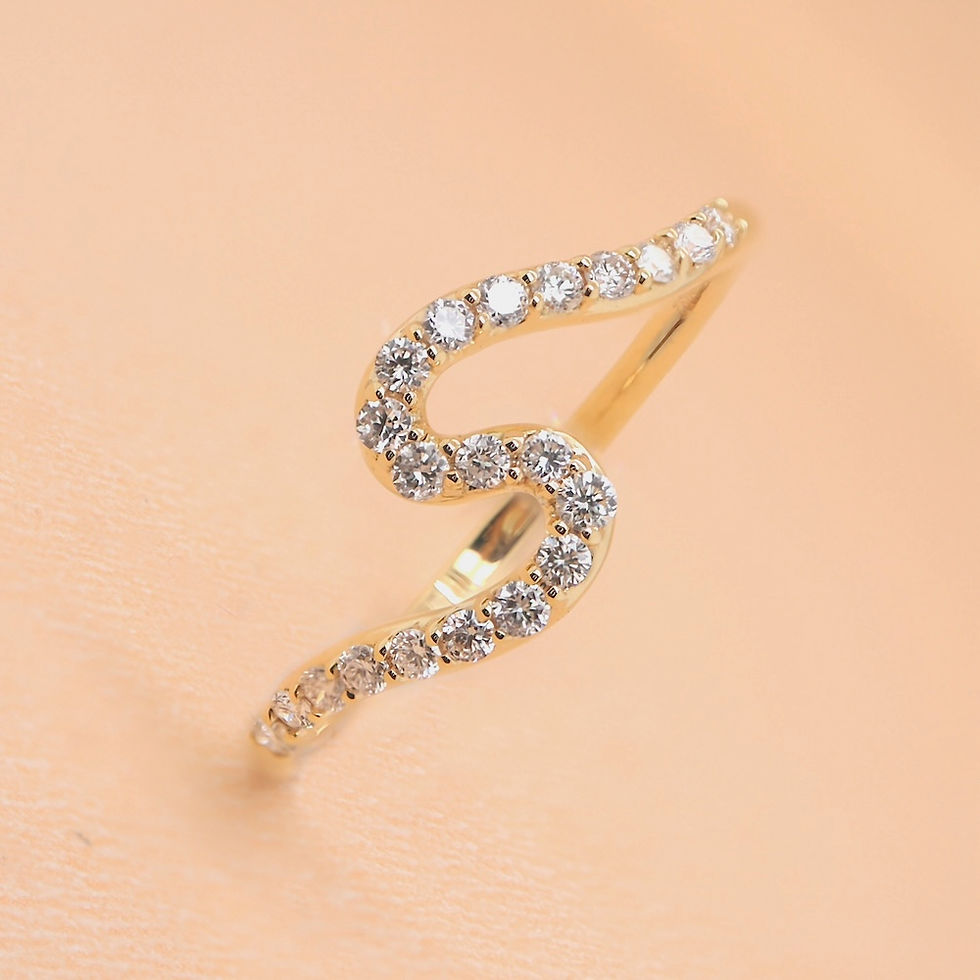 Thumbnail: Dainty wavy pavé diamond wedding ring in fine gold.