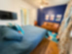 Month to month fully furnished rentals bedroom with blue wall