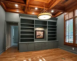 Custom study reconstruction with built-in cabinetry, hardwood flooring, and coffered ceiling after water damage in McKinney, TX