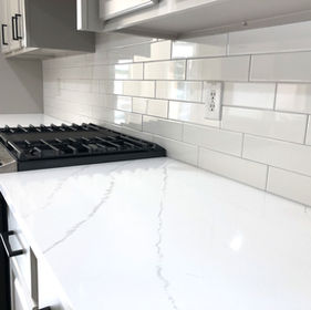 McKinney, TX white quartz countertop with staggered white porcelain backsplash tile