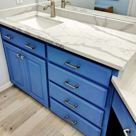 grey veined quart bathroom countertop on blue vanity cabinetry
