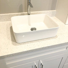 white porcelain sink on quartz countertop vanity