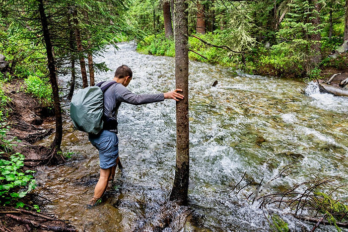 man-crossing-river-ford-on-conundrum-cre